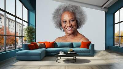 Happy black senior woman in a studio shoot Wall mural