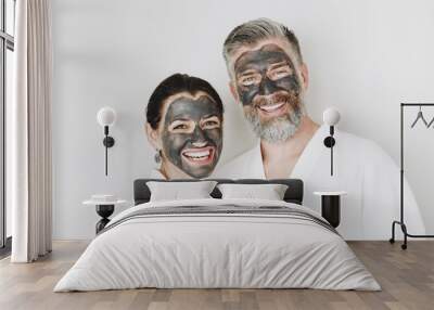 Happy couple wearing a charcoal mask Wall mural