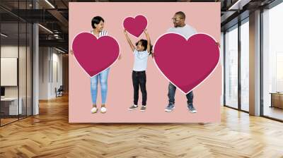 Happy family holding red heart icons Wall mural