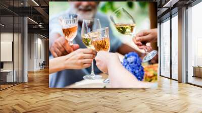 Happy people clinking wine glasses Wall mural