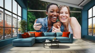 Happy women hugging each other Wall mural