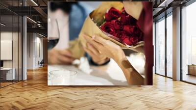 Man giving red rose bouquet Wall mural