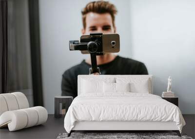 Man holding a gimbal with a phone Wall mural