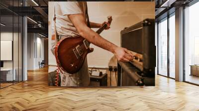 Musician setting guitar amp, studio recording session photo Wall mural