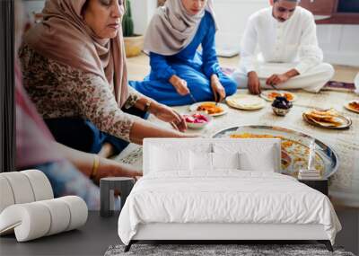 Muslim family having dinner on the floor Wall mural