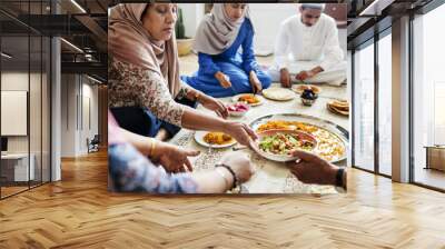 Muslim family having dinner on the floor Wall mural