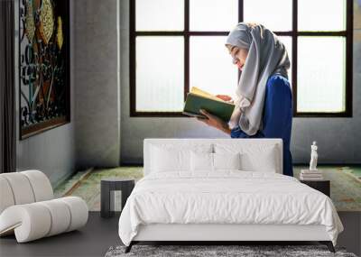 Muslim woman reading from the quran Wall mural