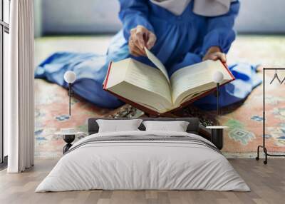 Muslim woman reading from the quran Wall mural