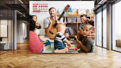 Nursery children playing with musical instruments in the classroom Wall mural