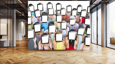 People Holding Tablets in front of The Face Wall mural