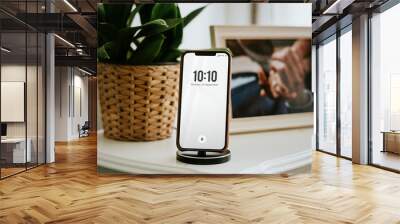 Phone charging on the bedside table Wall mural