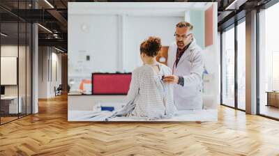 Physician doing a medical checkup on a patient Wall mural