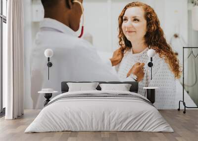 Physician examining a female patient Wall mural