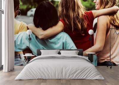 Rear view of a group of diverse woman friends walking together Wall mural