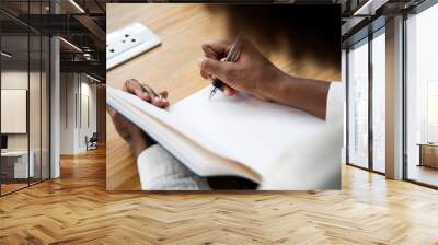 Rear view of woman writing a note Wall mural