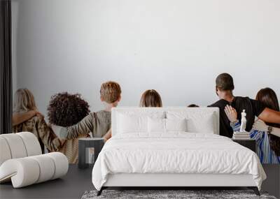 Rearview of diverse people hugging each other Wall mural