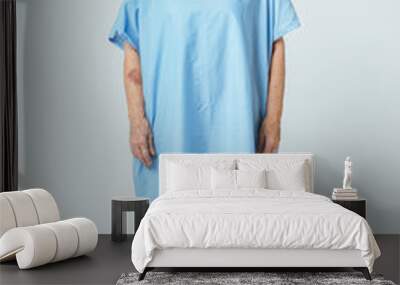 Sad senior patient in a hospital gown Wall mural