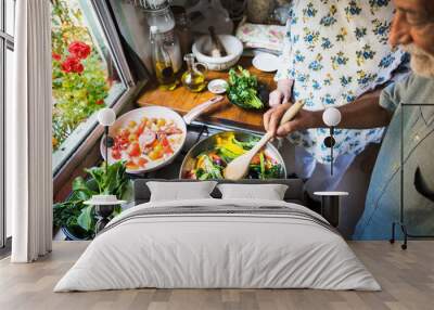 Senior couple cooking in the kitchen Wall mural