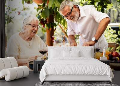 Senior couple having dinner outdoors Wall mural