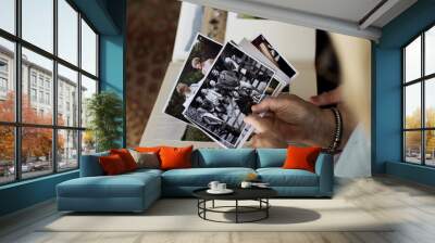 Senior couple looking at family photo album Wall mural