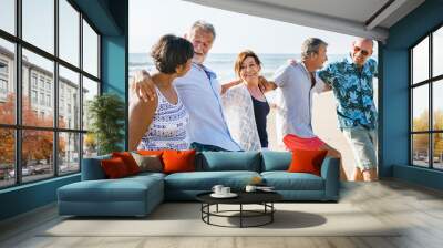 Senior friends playing at the beach Wall mural