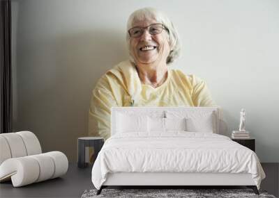 Senior woman arms crossed and smiling Wall mural