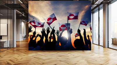 silhouettes of people holding flag of greenland Wall mural