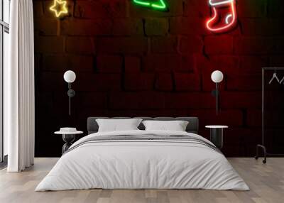 Stars, Santa hat, stocking and Christmas tree neon sign on a dark brick wall vector Wall mural