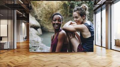 Two friends relaxing by a waterfall Wall mural