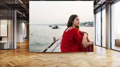 Western woman on a boat exploring the River Ganges Wall mural