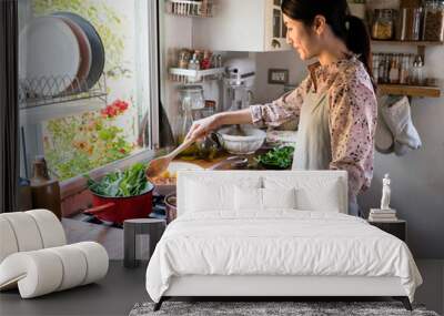 woman cooking lunch in a kitchen Wall mural