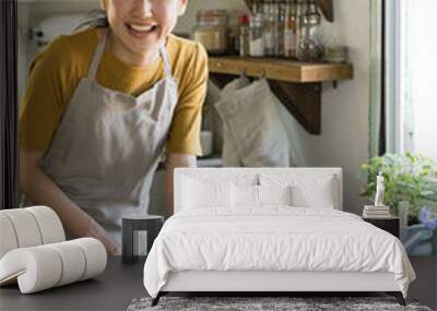 Woman cutting green onions in the kitchen Wall mural