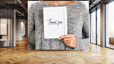 Woman holding a Thank You card Wall mural