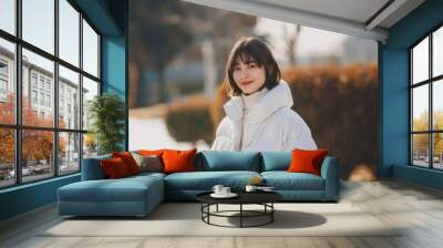 Woman outdoors winter coat smiling Wall mural