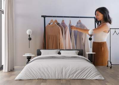 Woman selecting clothes Wall mural