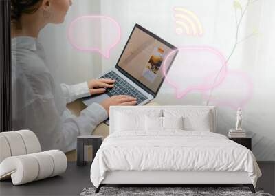 Woman using a laptop on a bean bag Wall mural