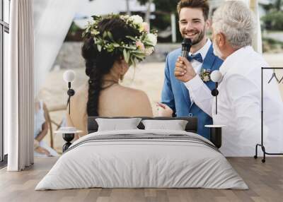 Young couple in a wedding ceremony at the beach Wall mural