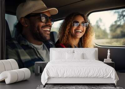 A happy couple on a road trip, smiling and wearing sunglasses inside a car Wall mural