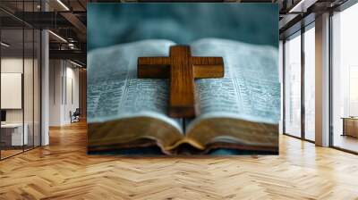 A wooden cross resting upon an open Bible capturing the essence of Christian fait Wall mural