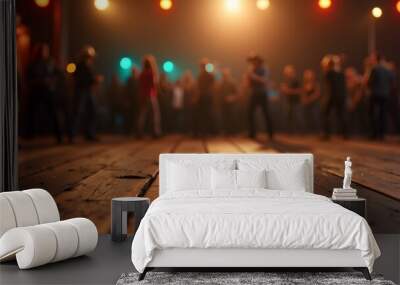 A wooden dance floor in focus with a blurred group of people dancing under warm, festive lighting Wall mural