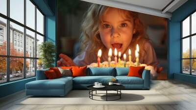 Little birthday girl blowing out candles on cake at home Wall mural