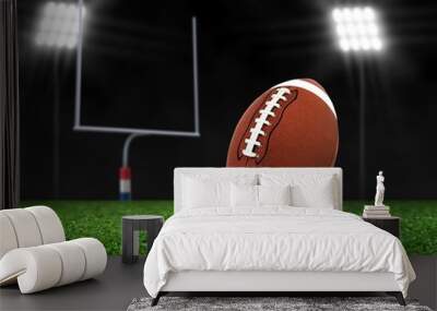 Football Ball On Grass under Spotlights Wall mural