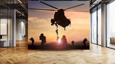 Special force assault team helicopter drops during sunset Wall mural