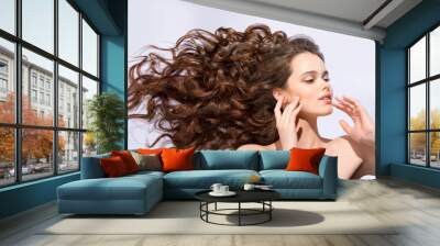 The girl's hair fluttering in the wind flow Wall mural