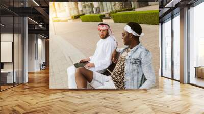 Two businessmen working on the go on a laptop together Wall mural