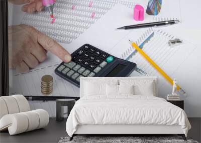 Accountant balancing a sales ledger with a calculator Wall mural