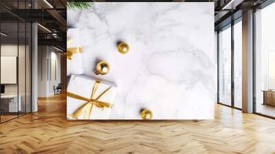 Festive Christmas and new year celebration image white gift boxes with gold ribbons fir branches and gold baubles on a white marble background Christmas banner with copy space Merry Christmas Wall mural