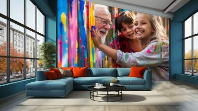 An elderly man and a young girl painting a fence together, smiling under their colorful paint smudges.  Wall mural