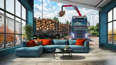 Big truck with crane arm loading the wood logs train. Cranes  work Wall mural