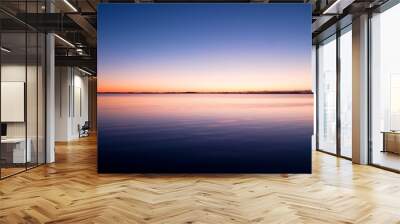 First light of day creates dramatic colors in the sky over Ocean. Wall mural